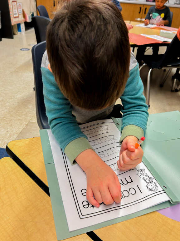 A little boy working on his handwritting.