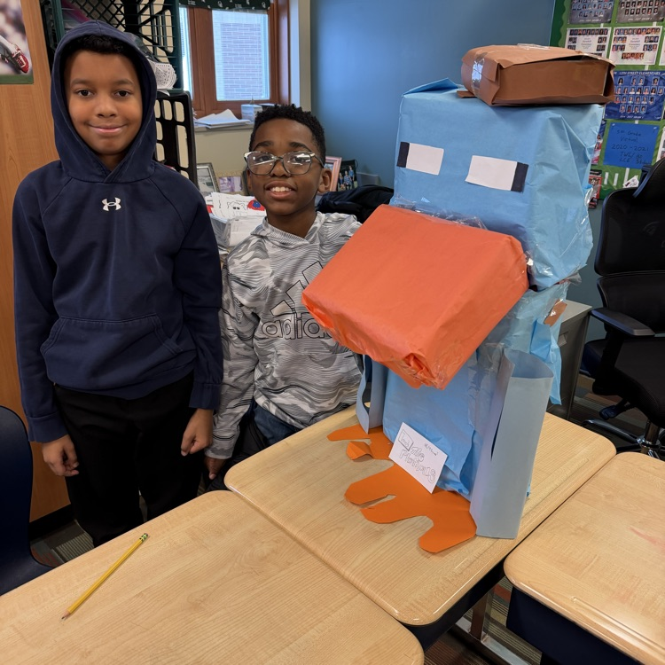students in a classroom with cardboard animals