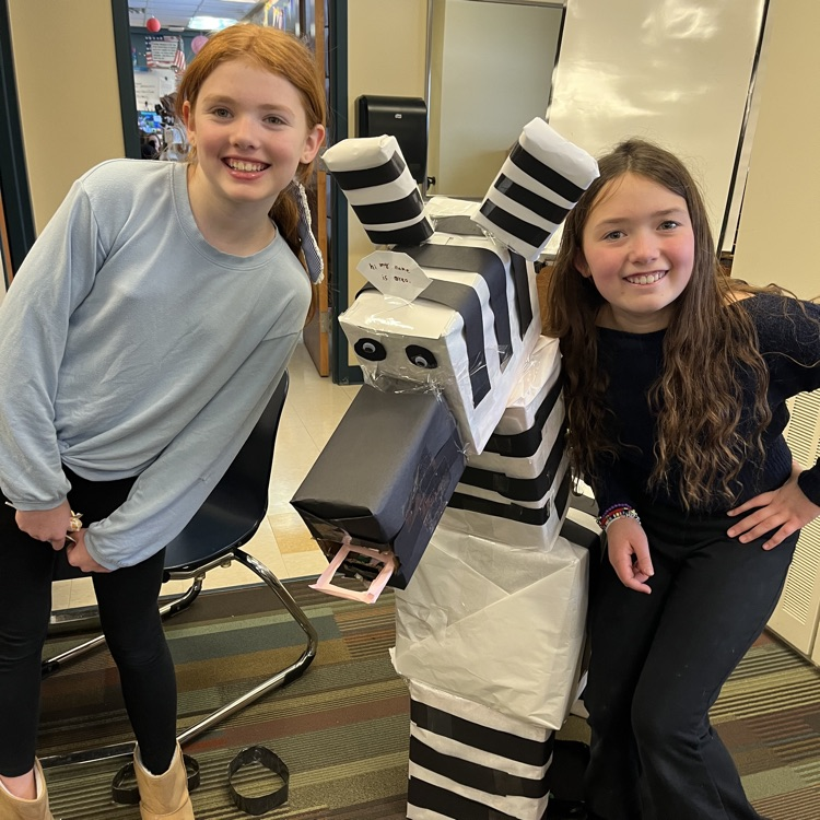 students with a cardboard zebra