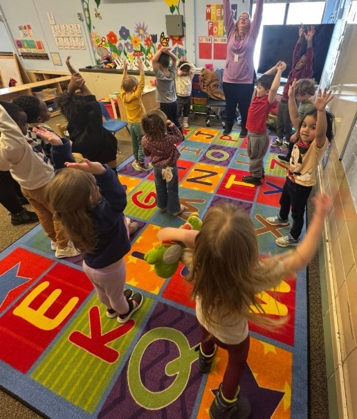 Students dancing on the carpet together.