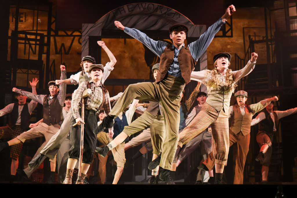 students performing in a musical on stage