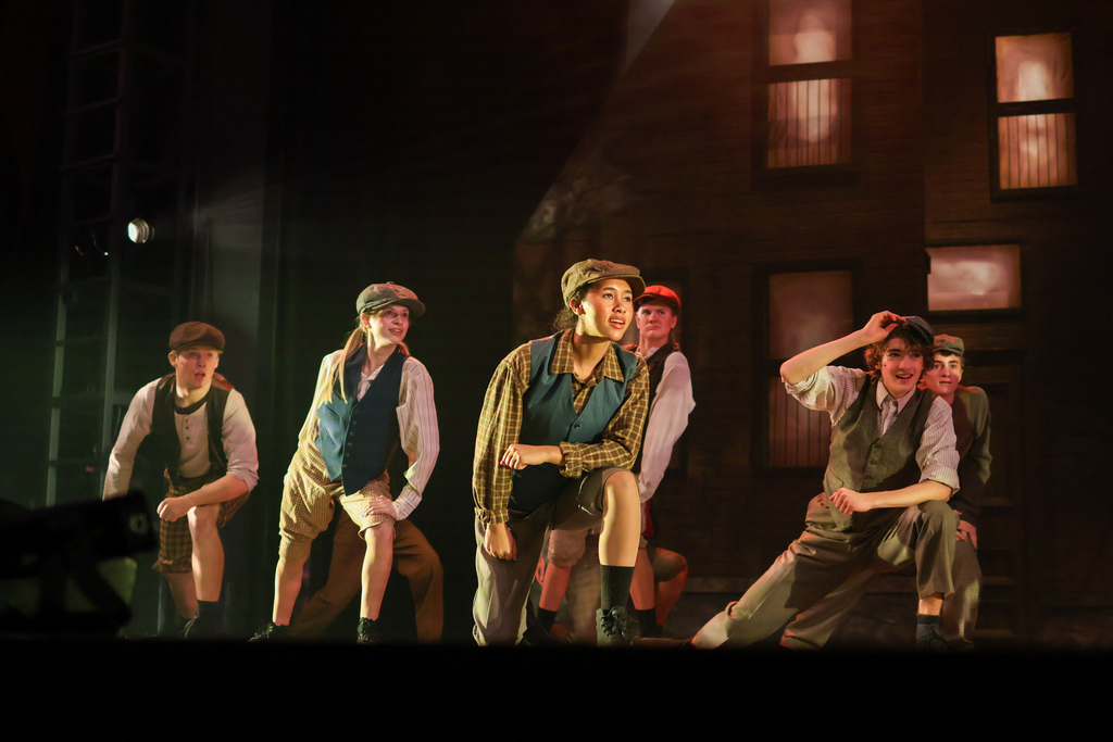 students performing in a musical on stage