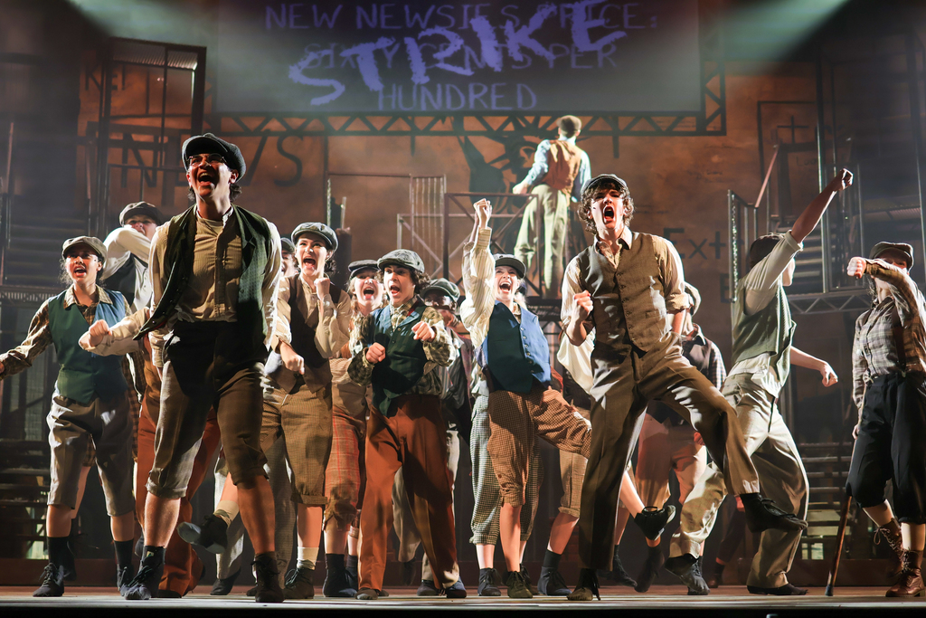 students performing in a musical on stage