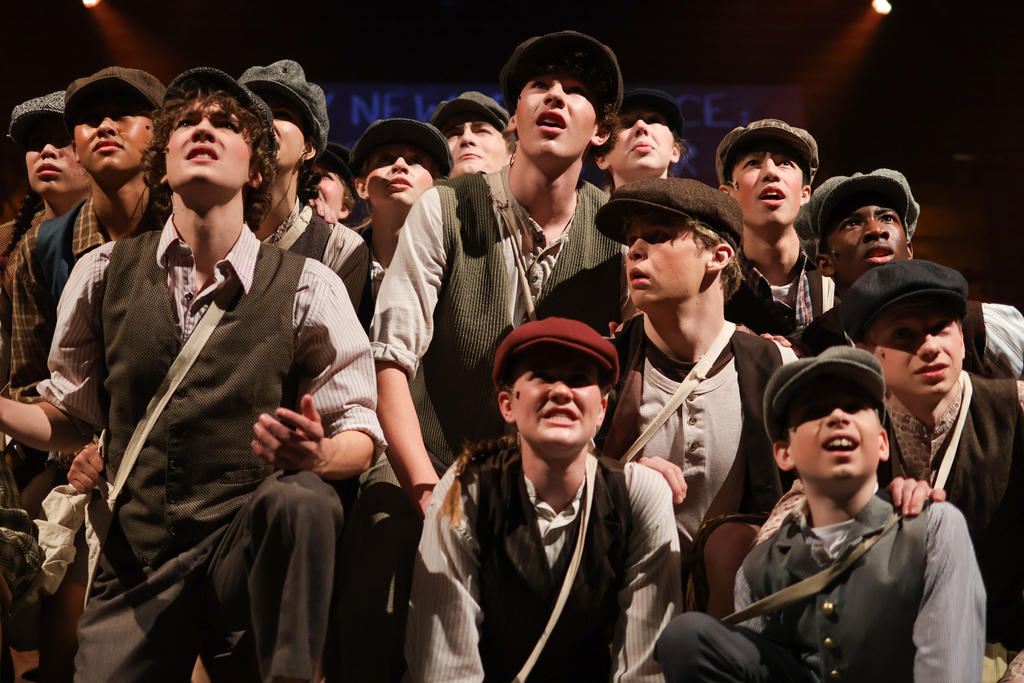 students performing in a musical on stage