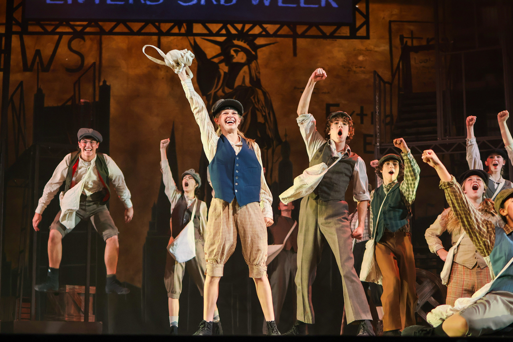 students performing in a musical on stage