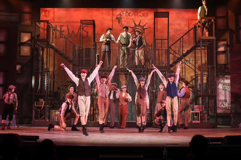 students performing in a musical on stage