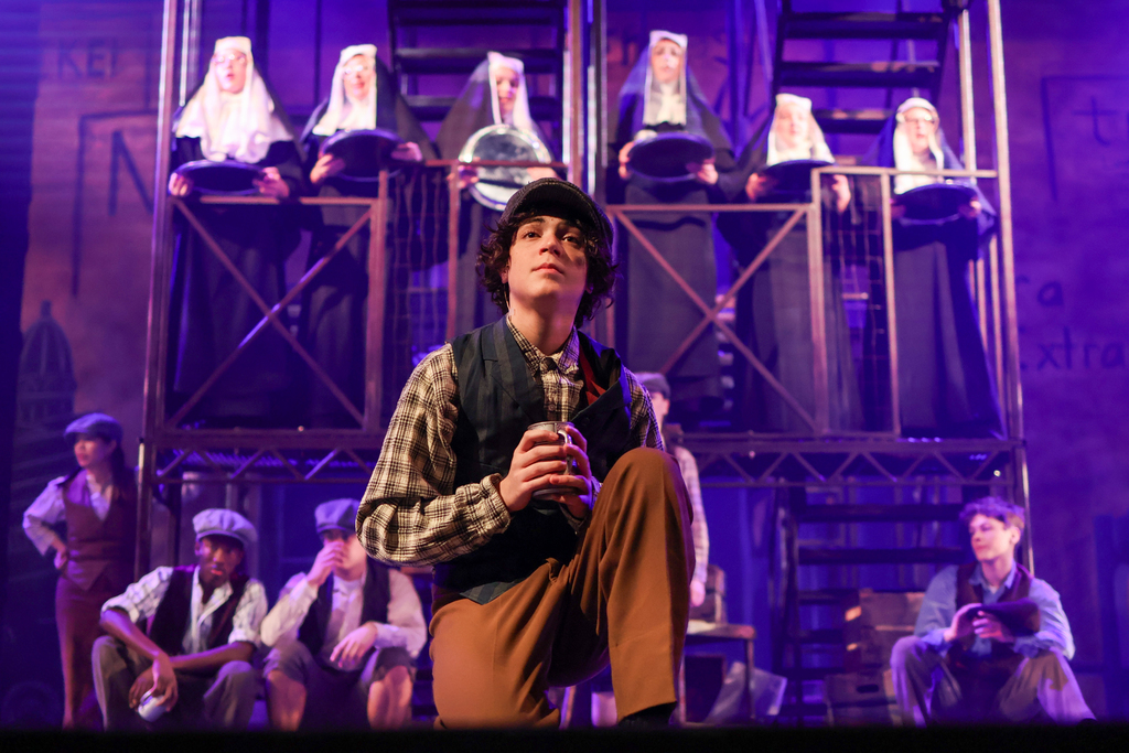 students performing in a musical on stage