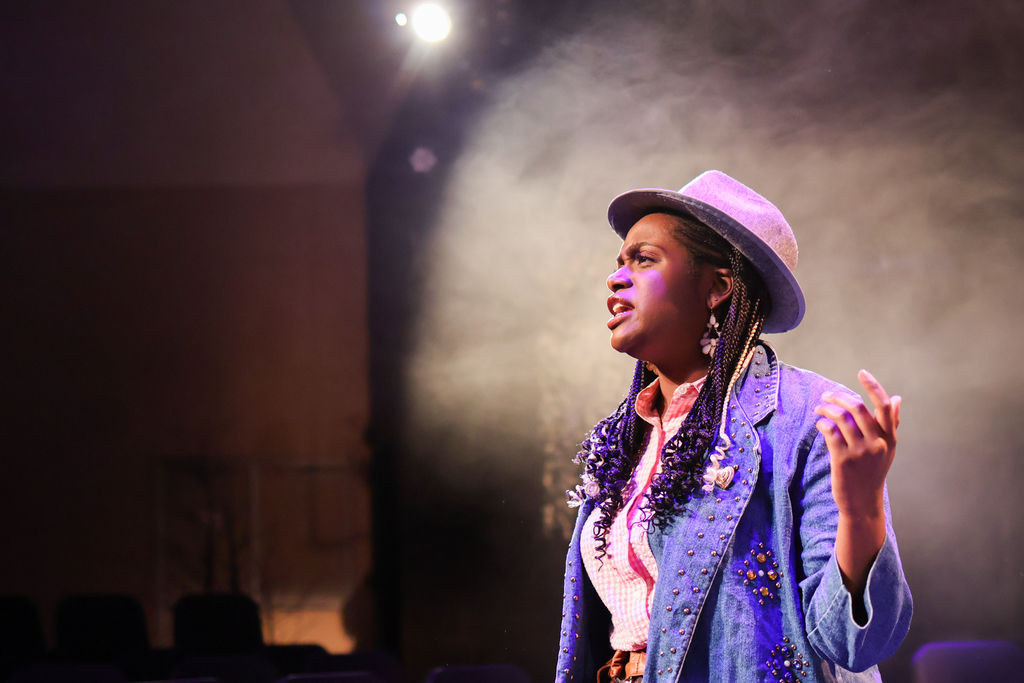 students perform in a musical on stage