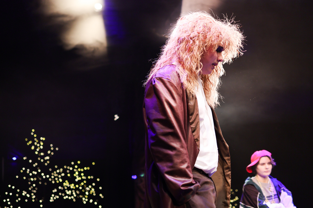 students perform in a musical on stage