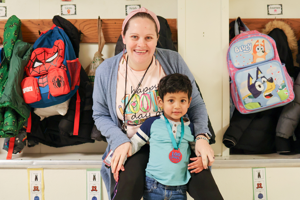 a teacher and student pose for a photo 