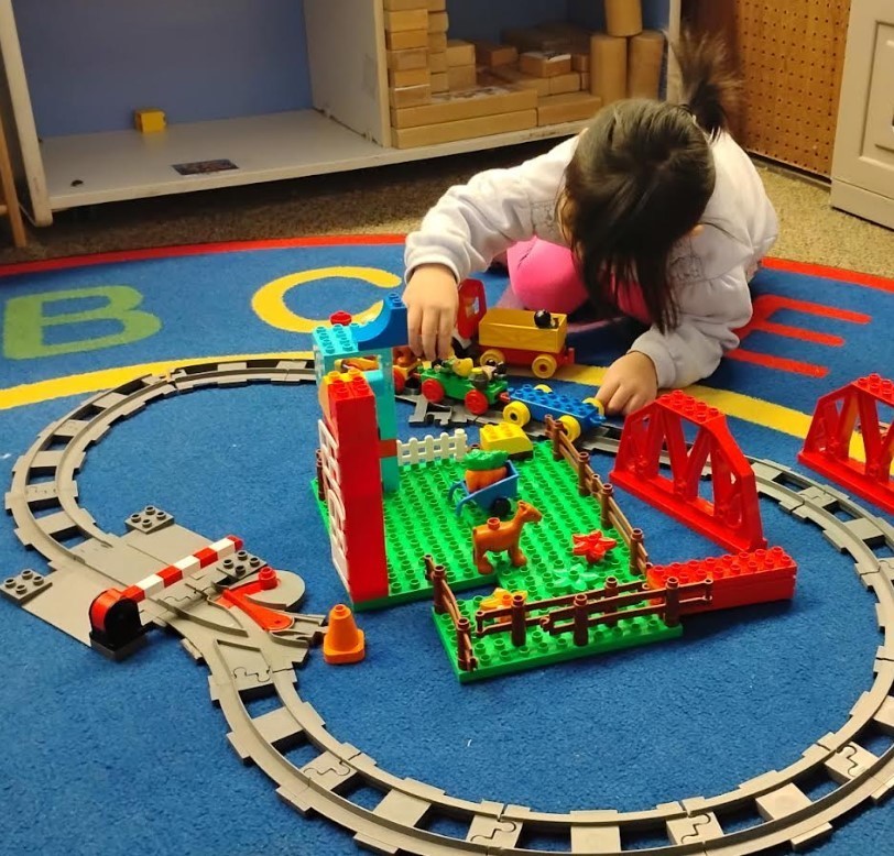 A female student building legos.