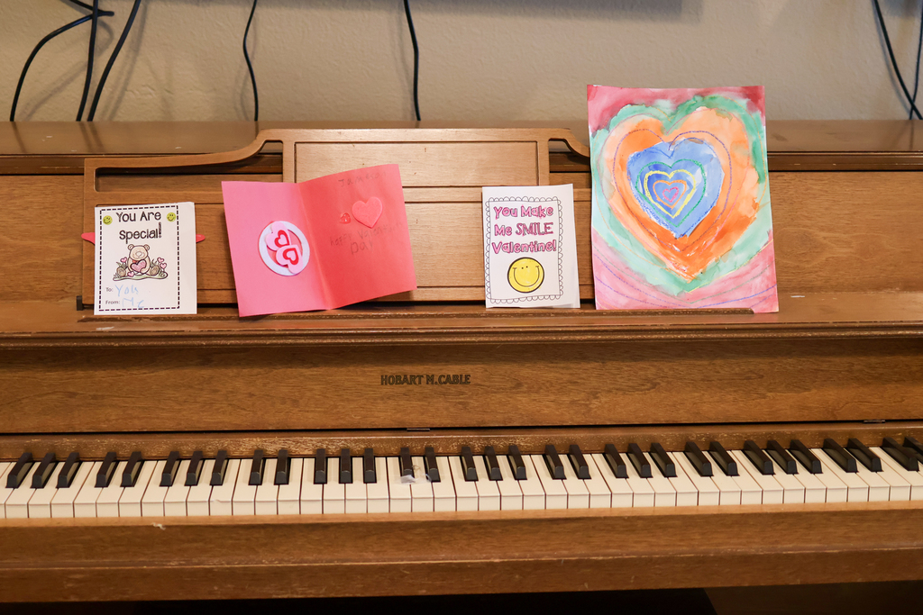 valentine's day cards lined up on a piano