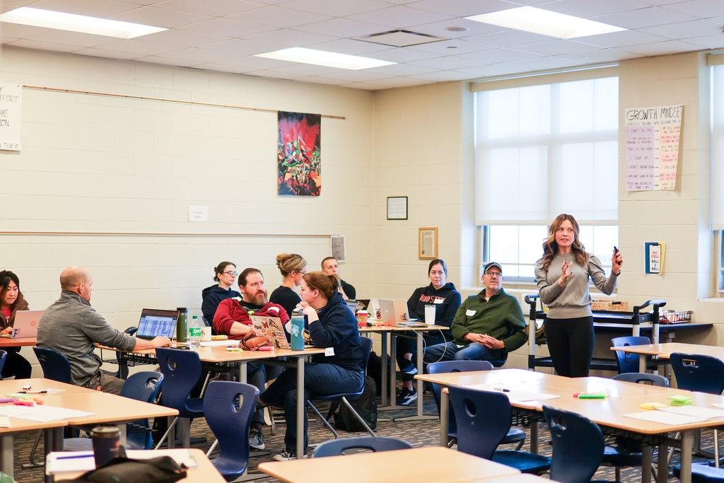 a woman speaking to a classroom full of teachers
