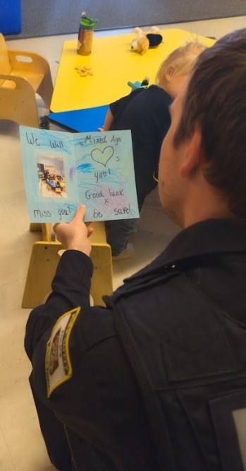 A police officer reading a card.