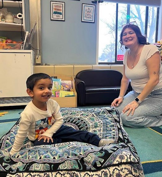 A teacher and a student working on gross motor skills together.