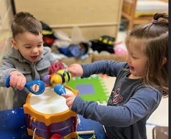 boy and girl playing with drums.