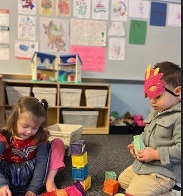 a girl and boy in dress up costumes.
