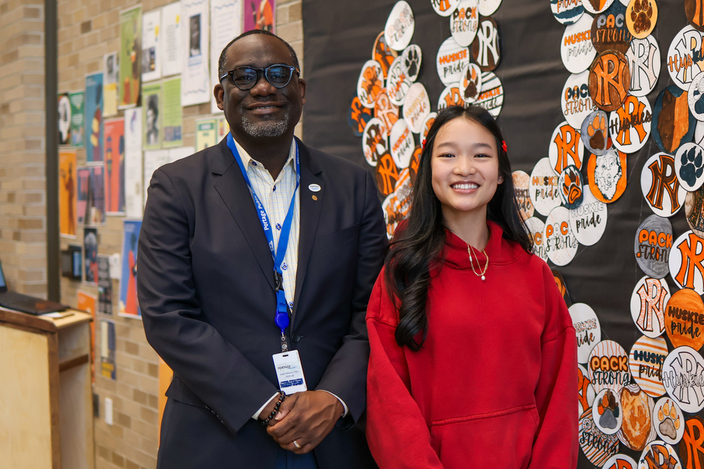 a man and student stand together for a photo