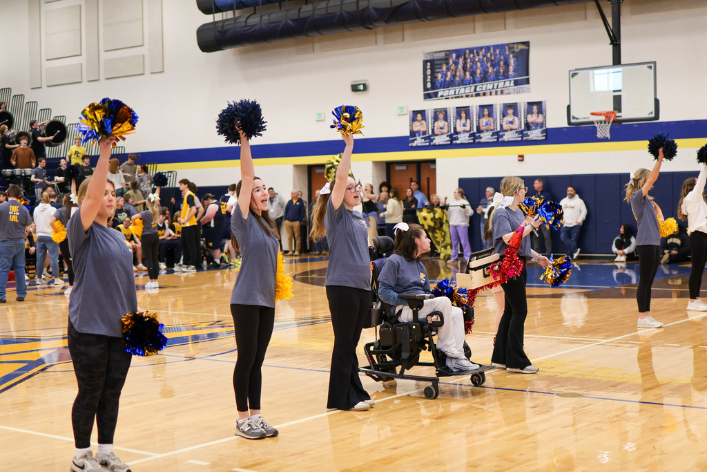students cheering inside a school gym