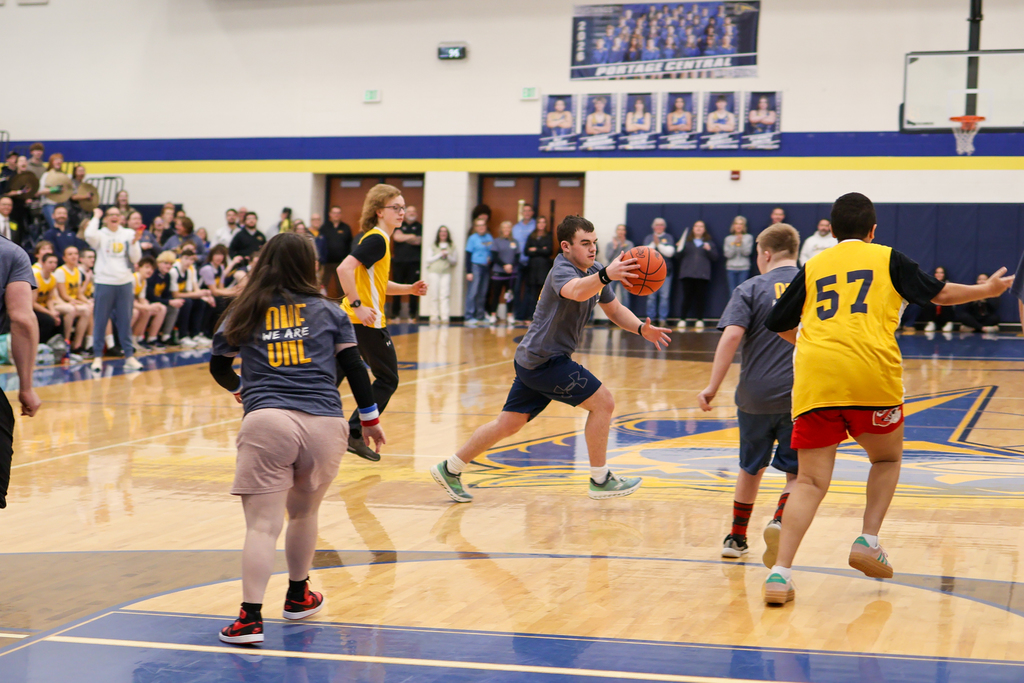 a boy running with a basketball during a game
