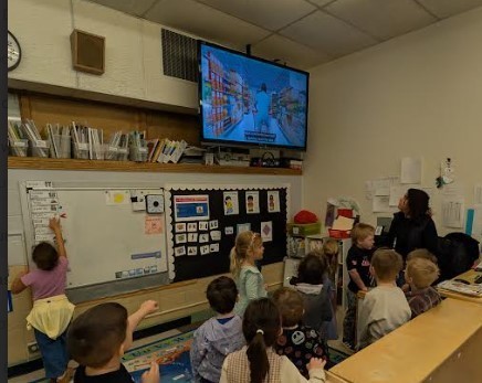 Students dancing together in a classroom.