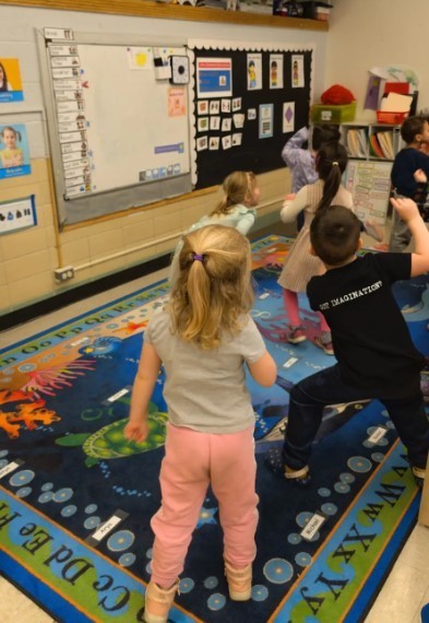 Several students at the carpet dancing to a song.