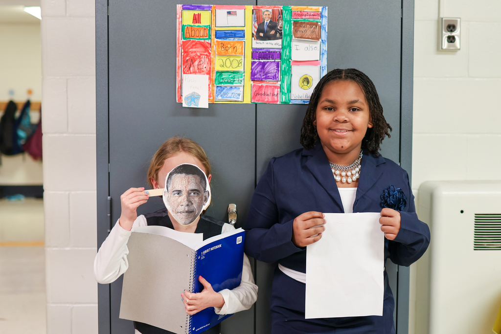 two students dressed as Barack Obama pose for a photo