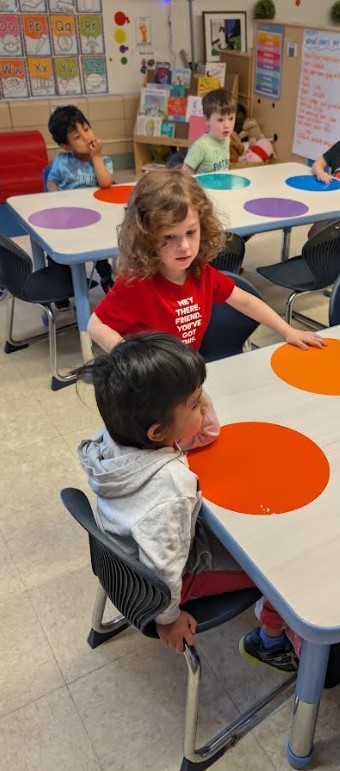 Students about to begin paitning with paint brushes. 