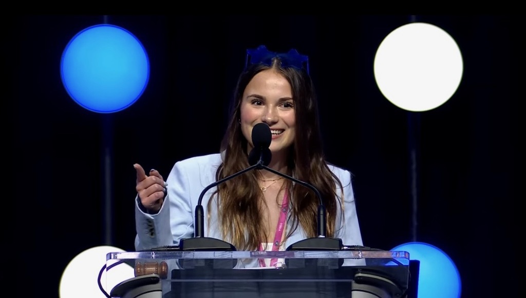 a girl speaking at a podium