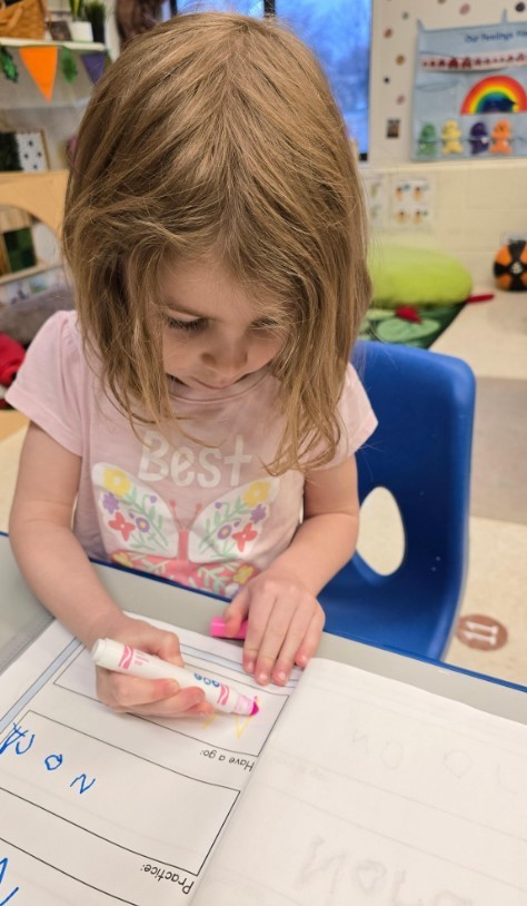 A female student working on her handwriting. 