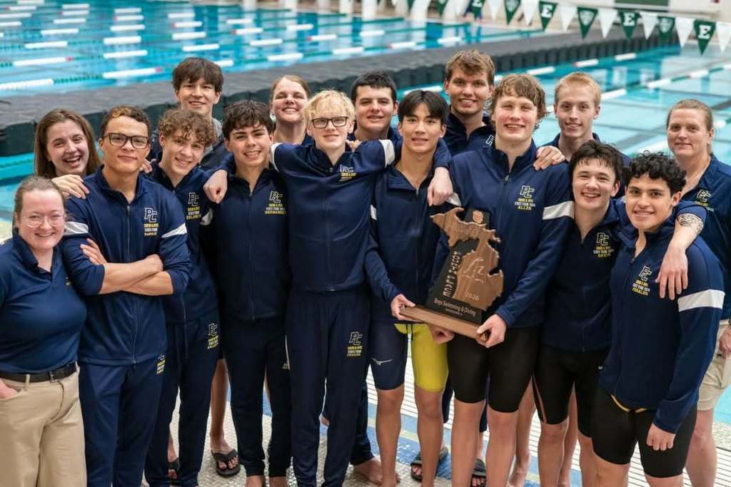 a group of boys pose for a photo with a state championship trophy