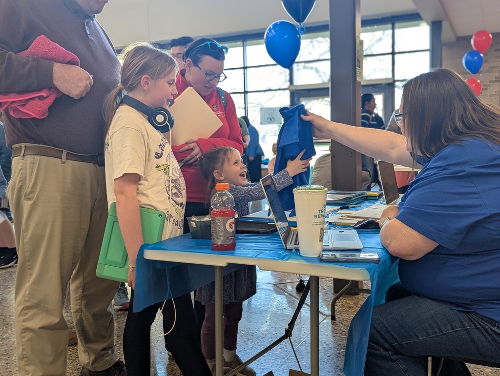 Young girl getting her first school t-shirt.