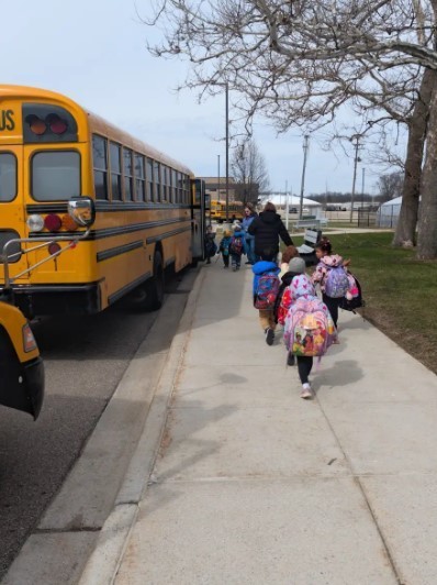 A group of students getting on the bus.