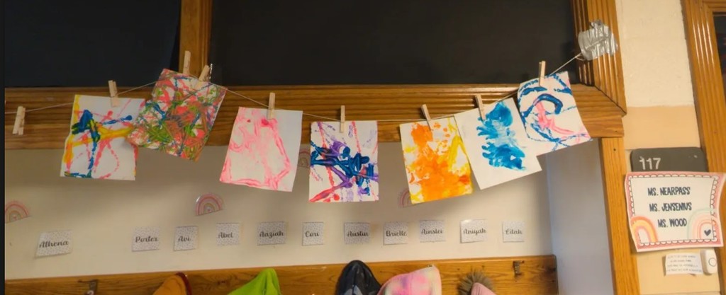 Student artwork hung in the hallway with bring colors.
