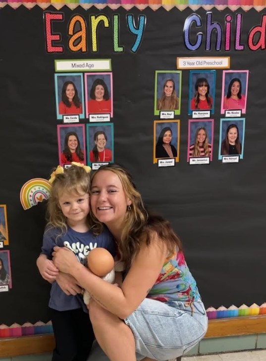 A teacher amd a two year old hugging.