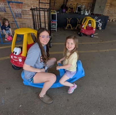 Big girl and a three year old on a teeter-totter together