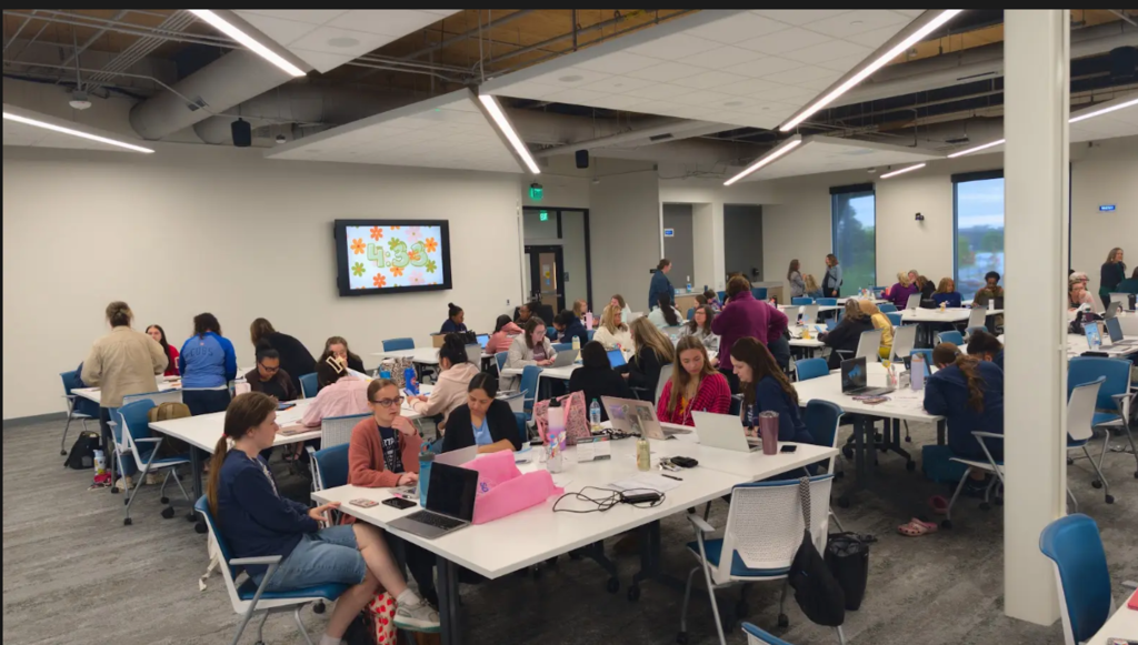 A large group of teachers sitting at tables together. 