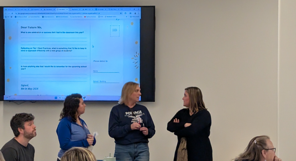 Three female teachers standing and talking together. 