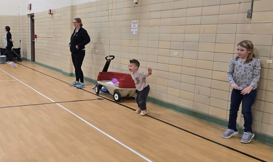 Kids jumping up an down in the gym.