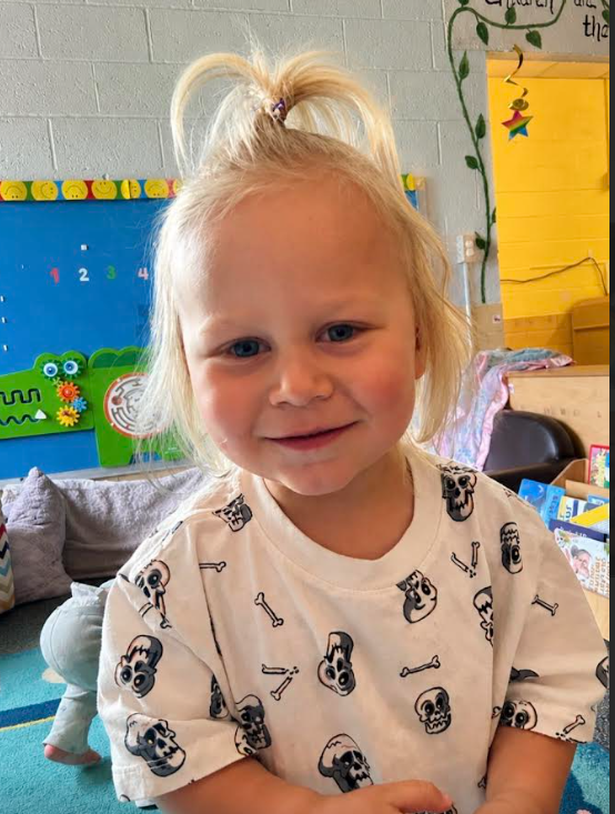 A little boy smiling at the camera.