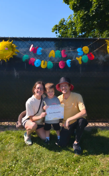 Two parents and a child posing for a picture together. 