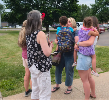 Families hugging their children.