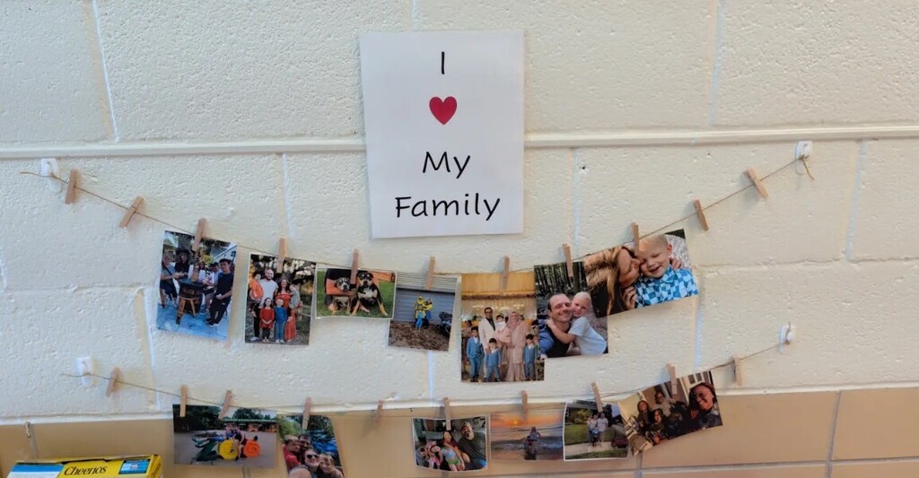 Family photos hung from a string in the classroom for students to look at.