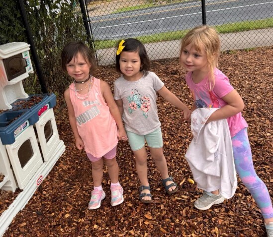 Students on the playground holding hands.