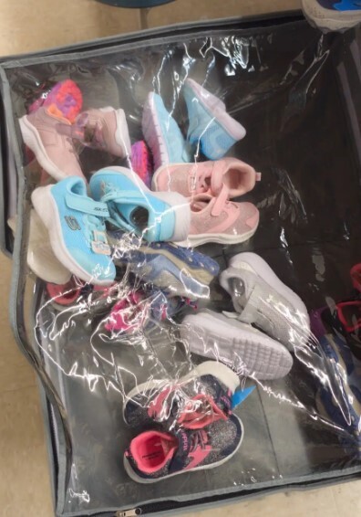 a pile of shoes on a bench.