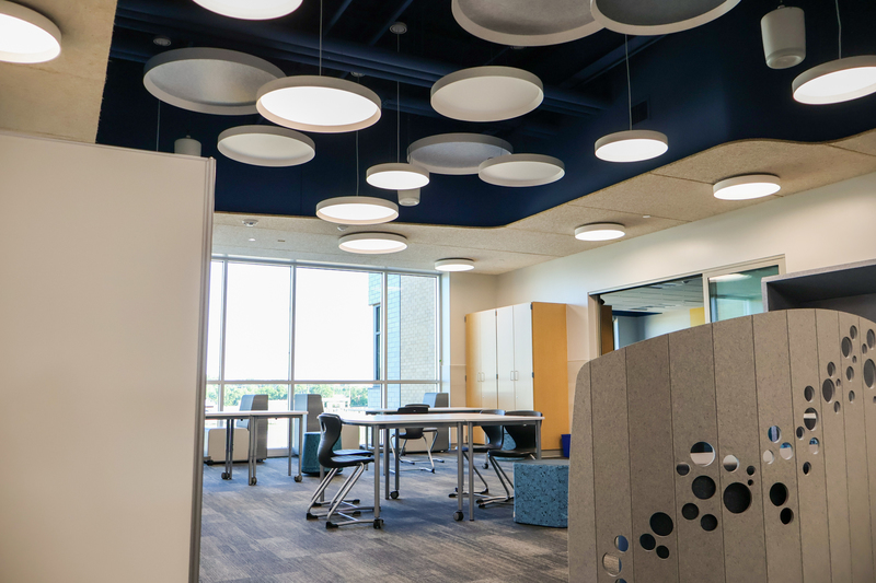 a classroom with overhanging circle lights