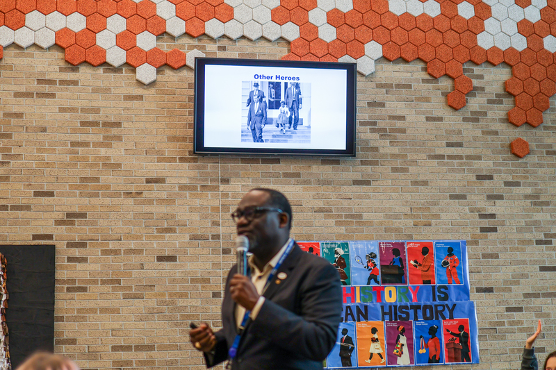 a man speaking in a cafeteria
