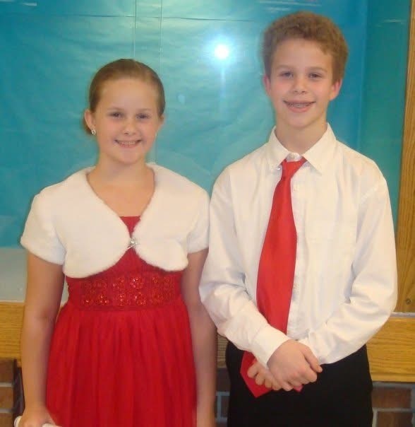 two middle schoolers pose for a photo