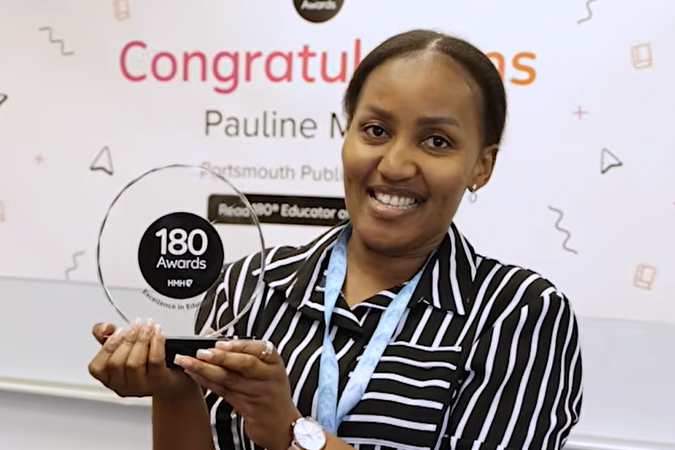 Pauline Miringu holding an award from Read 180 for Educator of the Year