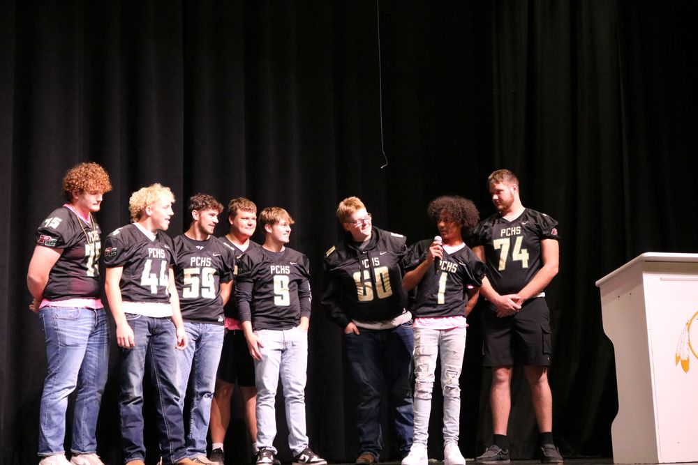 Darius and senior teammates on stage at homecoming pep rally
